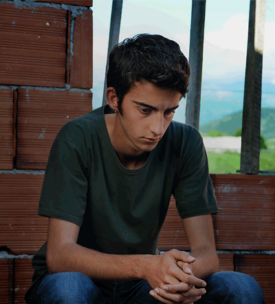 Forgive_2 Nik (Tristan Halilag) sits on the roof in Josh Marston’s FORGIVENESS OF BLOOD. Photo by Anila Jaho. A Sundance Selects release.